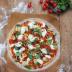 Pizza sin gluten con tomates cherry, berenjenas, piñones y mozzarella